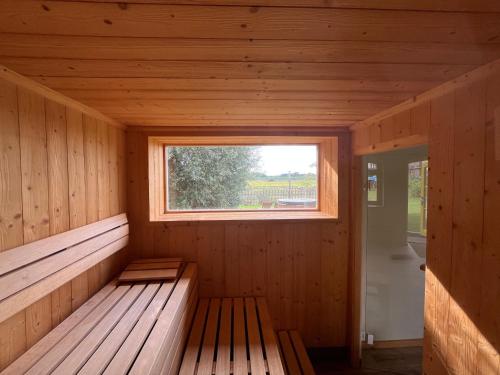 an empty wooden sauna with a window in it at Pension Bäumi-Hof in Seehausen