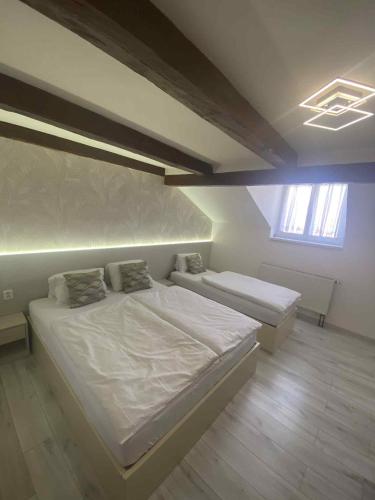 a bedroom with two beds and a window at Hotel U Radnice Aš in Aš