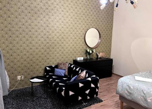 a living room with a couch and a mirror at Stylish Flat in Jewish District 7 in Budapest