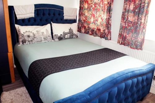 a bedroom with a blue and white bed with curtains at Central London rooms in London