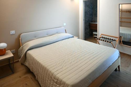 a bedroom with a bed in a room with a mirror at Serenity Apulian Rooms in Trepuzzi