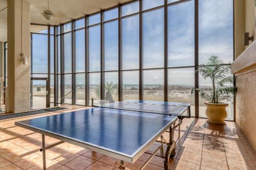 a tennis court in a room with large windows at Summerchase in Orange Beach