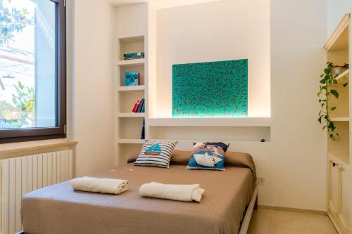 a bedroom with a bed with two pillows on it at Magnolia house- monolocale con ingresso indipendente in Civitanova Marche