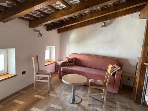 a living room with a couch and a table at SMARTnoOK Rooms and Apartment in Šmartno