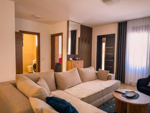 a living room with a couch and a table at TaNa's Apartments in Donji Štoj