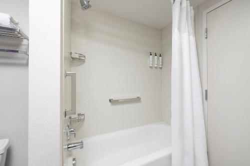 a bathroom with a shower with a white shower curtain at Fairfield Inn & Suites – Buffalo Airport in Cheektowaga