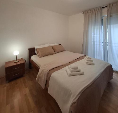 a bedroom with a bed with two towels on it at Galeb in Igalo