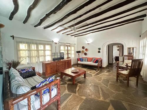 a living room with a couch and a table at Rafiki Villa in Mombasa