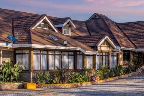a house with a gambrel roof at Naivasha Crescent Lodge in Naivasha