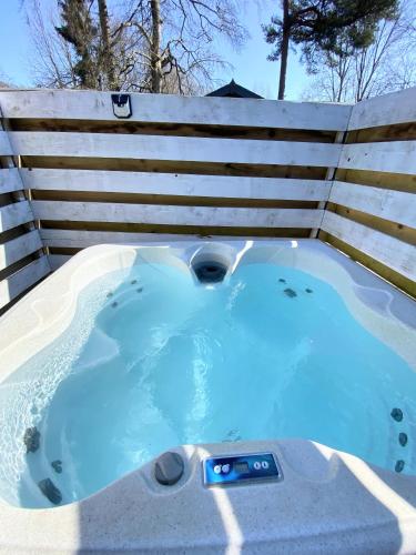 a hot tub in front of a fence at Beaver 1 HuntersMoon-warminster-Wiltshire in Warminster