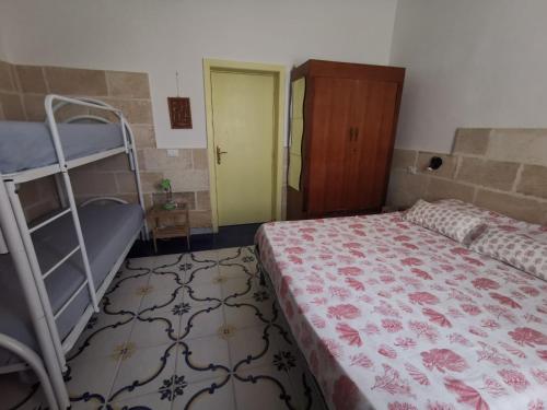 a bedroom with a bed and a bunk bed at Villa Lucky in Punta Prosciutto