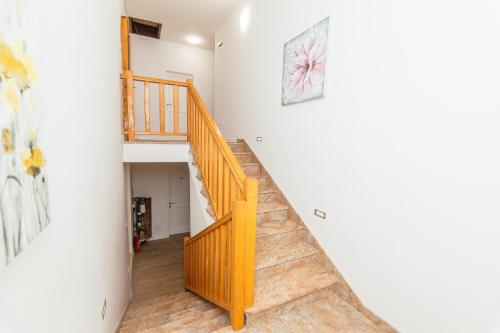 a staircase in a home with white walls at Pansion Čirjak in Sveti Filip i Jakov