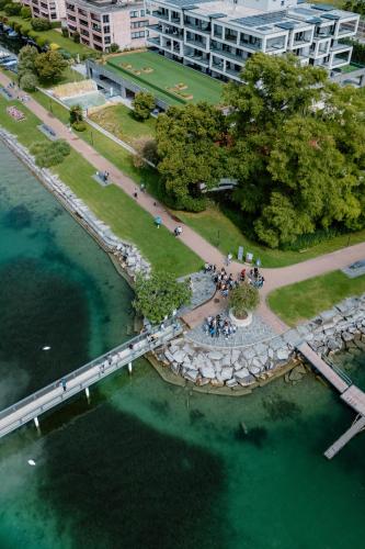 an aerial view of a park next to the water at Swiss Diamond Boutique Hotel - La Romantica in Melide