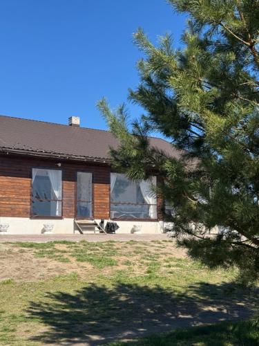 a house with a tree in front of it at Райське містечко «Акваторія» in Perlivka
