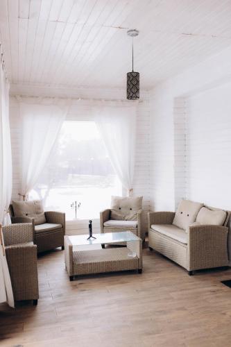 a living room with couches and a coffee table at Райське містечко «Акваторія» in Perlivka