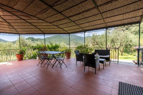 a screened in porch with a table and chairs at Ollie`s house in Leivi