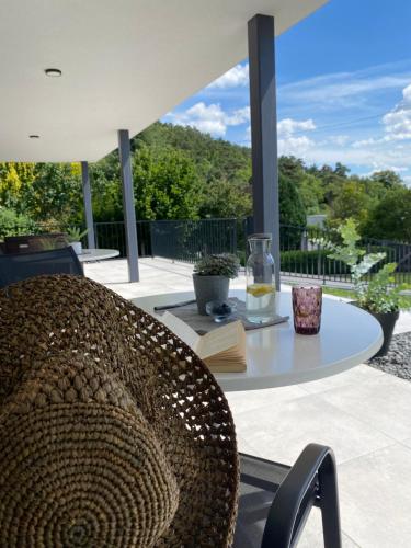 a chair sitting on a patio with a table at Peter`s Lucky Home Balaton, Vonyarcvashegy in Vonyarcvashegy