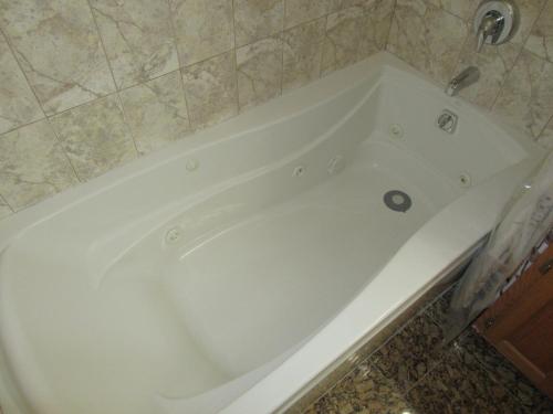 a large white bath tub in a bathroom at Hyde Park Shared Apartments in Chicago