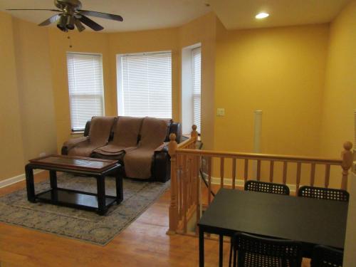 a living room with a couch and a table at Hyde Park Shared Apartments in Chicago