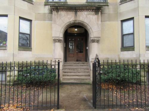 a gate in front of a building with a door at Hyde Park Shared Apartments in Chicago