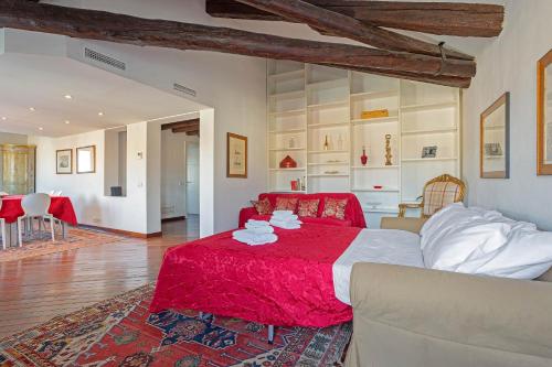 a bedroom with a red bed and a living room at Vip Venice Apartments and Rooms San Marco 5134 e 274 in Venice