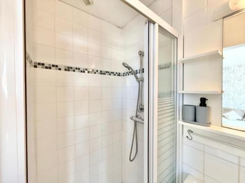 a bathroom with a shower with white tiles at Studio des brises centre-ville in Lorient