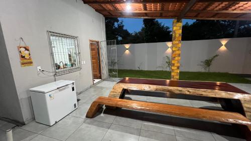 a patio with a wooden bench and a refrigerator at Casa Paraíso de Alter in Santarém