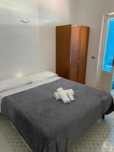 a bedroom with a bed with two towels on it at Eolian Villa Mare - Floating over the sea in San Salvatore