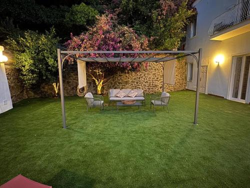 a pergola with a table and chairs in a yard at Bella Ischia in Ischia