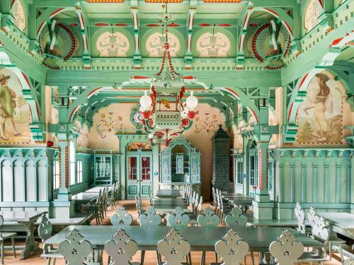a large room with a chandelier in a building at Apartmány Vila Hedvika in Rožnov pod Radhoštěm