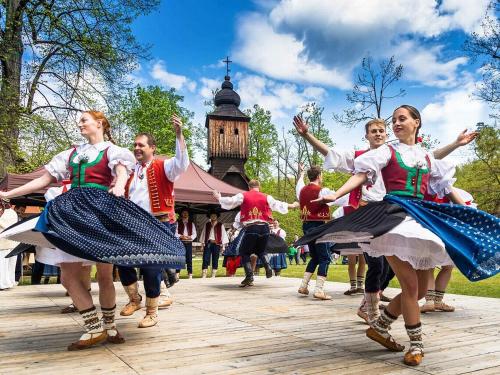 a group of people dancing in front of a tower at Apartmány Vila Hedvika in Rožnov pod Radhoštěm