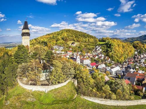 an aerial view of a small town with a tower at Apartmány Vila Hedvika in Rožnov pod Radhoštěm