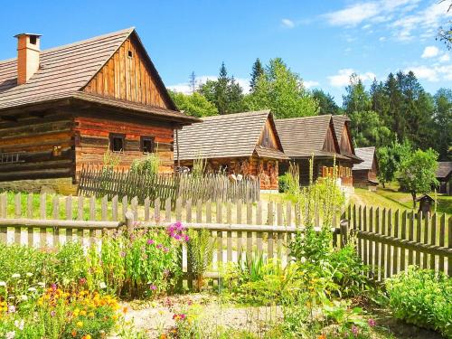 a wooden fence in front of a house at Apartmány Vila Hedvika in Rožnov pod Radhoštěm