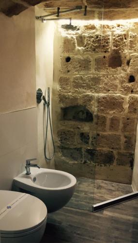 a bathroom with a sink and a toilet and a shower at La casa del nonno in Matera