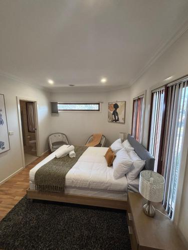 a bedroom with a large bed with white sheets and pillows at Urban Pause - Epping in Epping