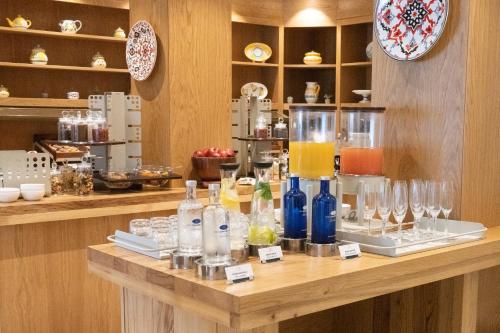 a counter with glasses and wine bottles on it at Swiss Diamond Boutique Hotel - La Romantica in Melide