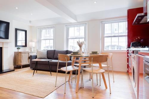 a living room with a table and a couch at Bright Carnaby Soho 1BR Apartment with AC in London