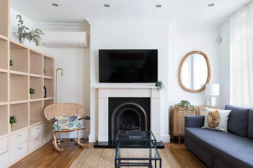 a living room with a couch and a fire place at Modern Carnaby Soho 1BR Apartment with AC in London