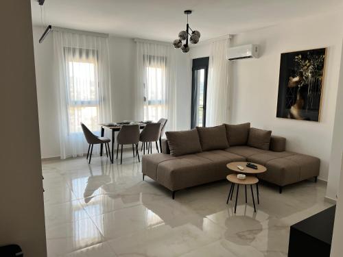 a living room with a couch and a table at Apartment L&L in Bar