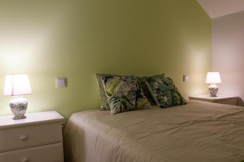 a bedroom with a bed with two night stands and two lamps at Casa do Pescador - Vila Nova de Cerveira in Vila Nova de Cerveira