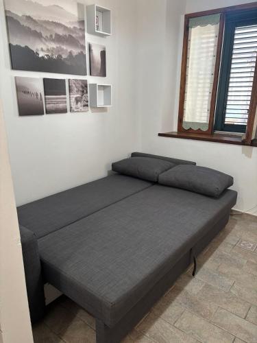 a bedroom with two beds and a window at La Lucanella in centro a Rotonda in Rotonda