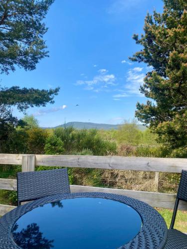 a table and chairs with a blue table and a view at Bynack Lodge in Boat of Garten