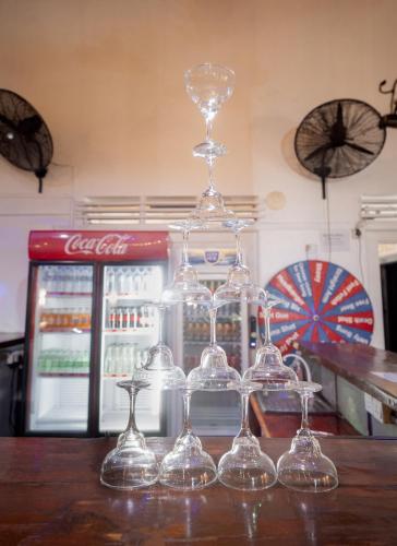 a group of wine glasses sitting on top of a counter at Why Not Hostel in Mirissa