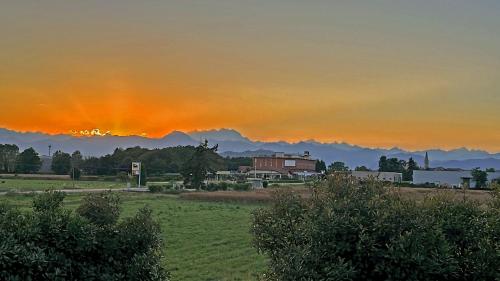 a sunset over a field with a house in the background at Guest House Sant'Antonio 