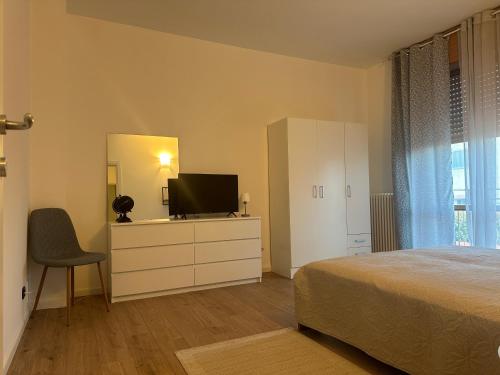 a bedroom with a bed and a dresser with a television at Guest House Sant'Antonio 