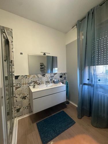 a bathroom with a sink and a shower with a mirror at Guest House Sant'Antonio 