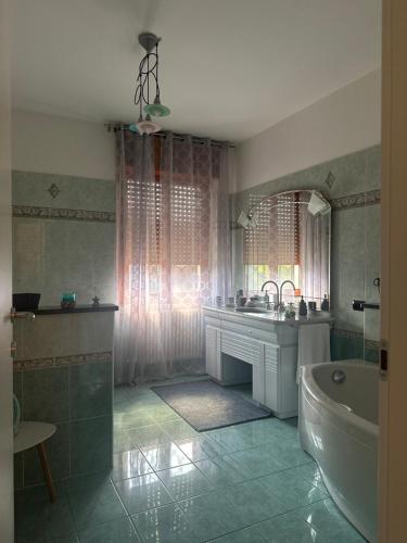 a bathroom with a tub and a sink and a bath tub at Guest House Sant'Antonio 