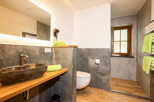 a bathroom with a sink and a toilet at Lacklehen in Ramsau