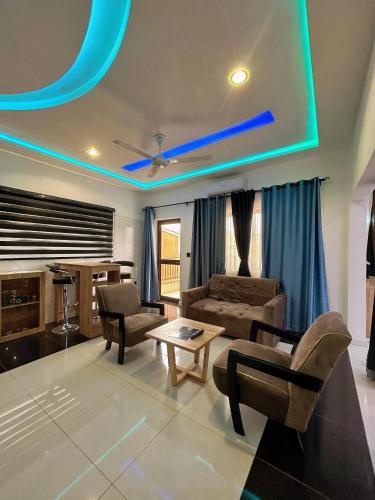 a living room with blue lights on the ceiling at Bekouvi Smart Suite - City & Sea in Cotonou