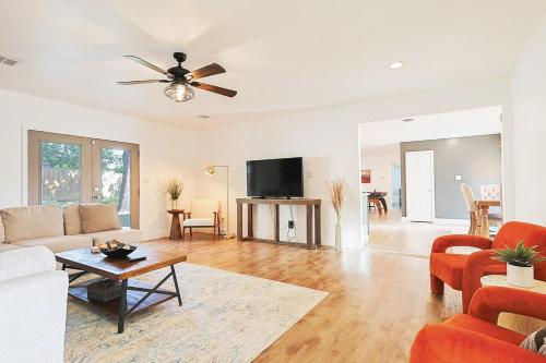 a living room with a couch and a tv at The Dallas Hub - Spacious 4BR - Prime location in Farmers Branch